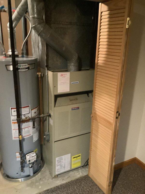 Completed installation of new 80% efficiency gas furnace in residential utility closet. Unit installed alongside existing water heater with proper clearances maintained, supply and return ductwork connected, venting routed through existing infrastructure, and all gas and electrical connections made to code. System tested and verified operational.