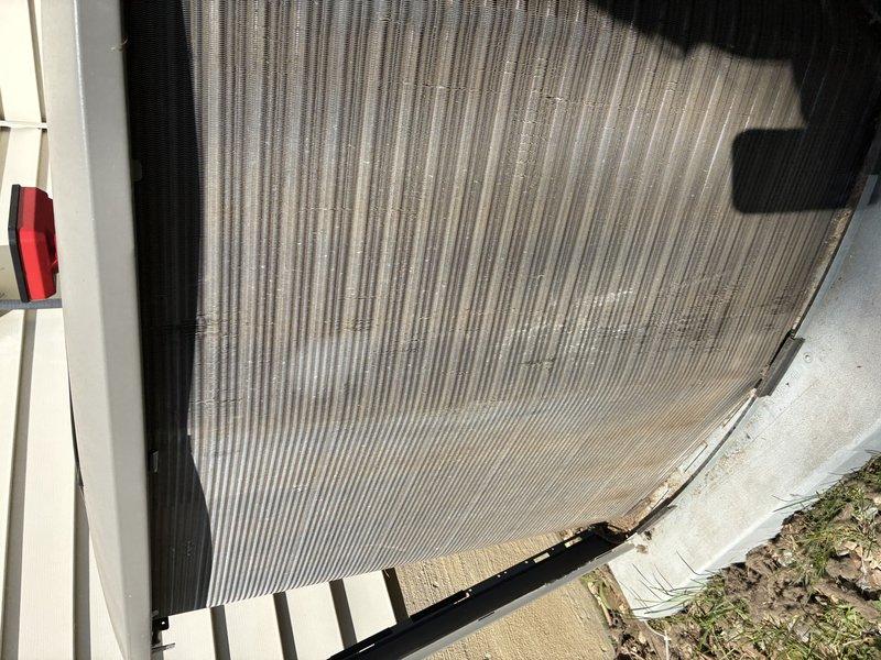 Completed MVP cooling maintenance visit on residential HVAC system. Performed comprehensive inspection of evaporator coil assembly, noting moderate dust accumulation on aluminum fins and verifying integrity of copper refrigerant lines and electrical connections. Inspected outdoor condenser unit, confirming proper installation and operational condition of coil section with ribbed panel construction. All components photographed and documented for maintenance records.