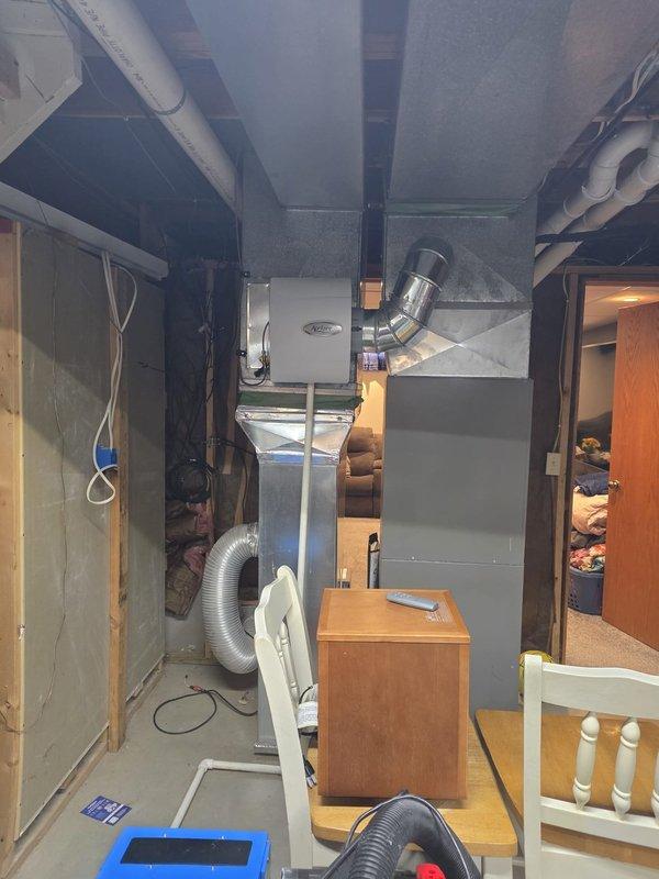 Completed routine maintenance on 7-year-old residential air conditioning system during scheduled early morning service window. Performed comprehensive inspection of ductwork throughout basement utility area, evaluating system for potential cleaning needs and identifying accessible duct runs connected to furnace unit. All visible ductwork, including metallic supply ducts and flexible return air ducting, was assessed for debris accumulation, proper connections, and overall condition to determine cleaning recommendations.