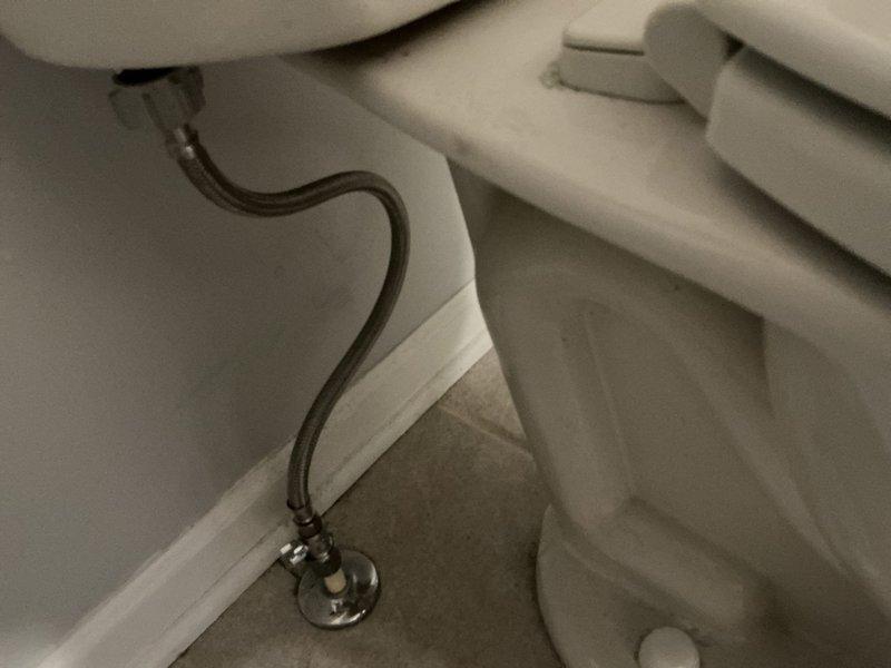 Responded to a second floor bathroom toilet experiencing intermittent running water and a broken shut-off valve handle. Replaced the fill valve, installed a new 3-inch flapper, and replaced the water supply line with a braided stainless steel flex line. Installed a new angle stop shut-off valve at the wall connection to restore proper water control to the fixture. All components were tested for proper operation and verified no leaks were present at connections. Toilet now functions properly with full shut-off capability restored.