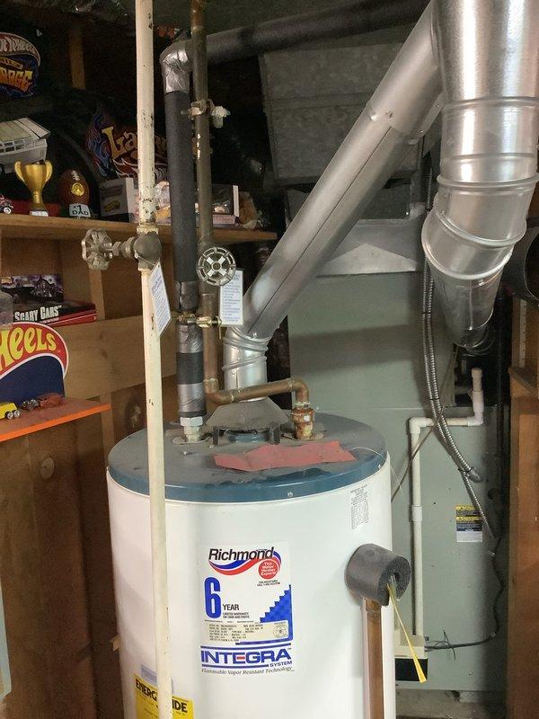 Provided estimate for replacement of 20-year-old Richmond Integra water heater with 6-year warranty that was leaking from the bottom. The existing unit had previously had its expansion tank removed by the city due to code violations related to its placement near an exterior wall, and subsequently developed a tank leak requiring full replacement.