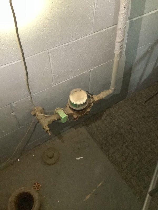 Responded to emergency call for water backing up in basement. Upon arrival, assessed the basement utility area and identified a clogged floor drain as the source of the backup. The drain showed visible signs of water staining and moisture around the fixture, with discoloration and rust deposits visible within the drain opening. 

Utilized drain snake equipment to clear the blockage in the floor drain line. Successfully removed obstruction and restored proper drainage flow. Tested the system to verify water was draining correctly and no further backup was occurring. The drain assembly, including the PVC piping and floor drain fitting, was inspected for proper function. Cleared debris from the immediate area around the drain opening and confirmed all plumbing components were operating as intended.