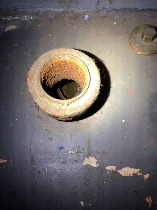 Responded to emergency call for water backing up in basement. Upon arrival, assessed the basement utility area and identified a clogged floor drain as the source of the backup. The drain showed visible signs of water staining and moisture around the fixture, with discoloration and rust deposits visible within the drain opening. 

Utilized drain snake equipment to clear the blockage in the floor drain line. Successfully removed obstruction and restored proper drainage flow. Tested the system to verify water was draining correctly and no further backup was occurring. The drain assembly, including the PVC piping and floor drain fitting, was inspected for proper function. Cleared debris from the immediate area around the drain opening and confirmed all plumbing components were operating as intended.