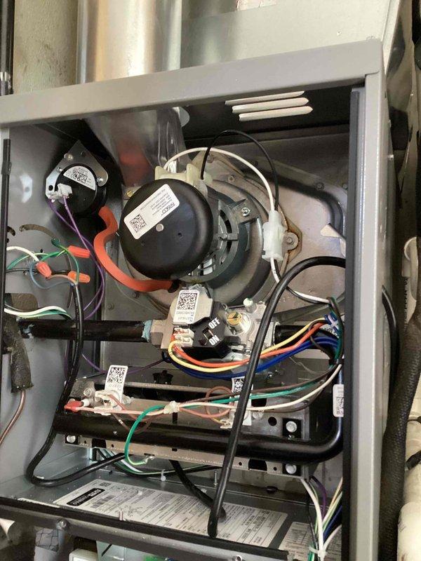 Completed routine preventive maintenance cooling visit on residential HVAC system. Accessed property using provided entry code, performed comprehensive inspection of furnace and cooling components including blower motor assembly, electrical connections, and internal wiring systems. Documented equipment condition through photographic records showing all major components, connections, and manufacturer specification labels for service history records.