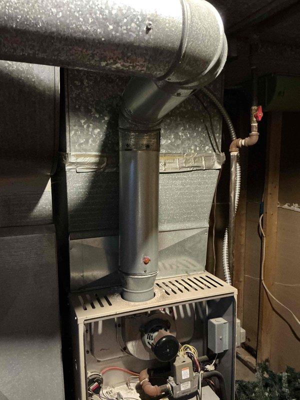 Conducted on-site assessment for air conditioning installation estimate at property with no existing AC system. Evaluated 25-year-old existing furnace for potential replacement, documenting current equipment condition through detailed photography of internal components including gas valve, ignition system, blower assembly, and associated wiring. Observed significant condensation accumulation on main trunk ductwork, indicating potential insulation deficiency that would need to be addressed during AC installation to prevent efficiency loss and moisture issues. Provided comprehensive replacement options for both cooling system addition and furnace upgrade to modernize complete HVAC system.