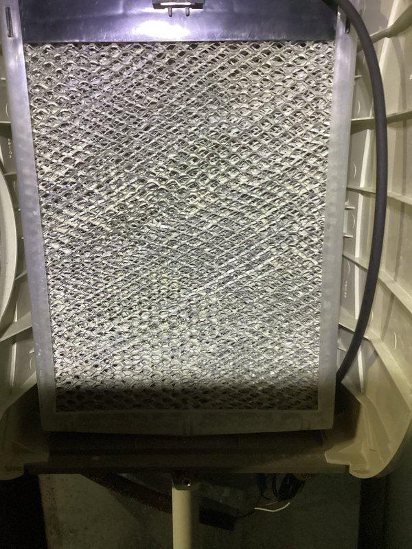 Completed MVP recurring cooling maintenance visit. Inspected outdoor condenser unit and found coils heavily contaminated with dust, dirt, and debris accumulation, significantly impacting heat transfer efficiency. Documented excessive buildup on finned coils and surrounding area with plant debris present in landscaping rocks. Inspected indoor air handler and found air filter heavily soiled with dust and particulate matter throughout the mesh media. Filter condition indicated restricted airflow and reduced system performance. Documented both components' conditions for maintenance records.
