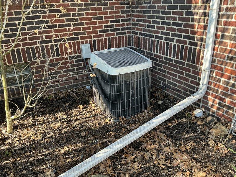 Completed HVAC system replacement estimate for 25-year-old air conditioning system. Assessed existing indoor air handler unit located in utility space and outdoor condenser unit positioned against exterior brick wall. Documented equipment conditions and provided quote for complete system replacement with updated equipment specifications.