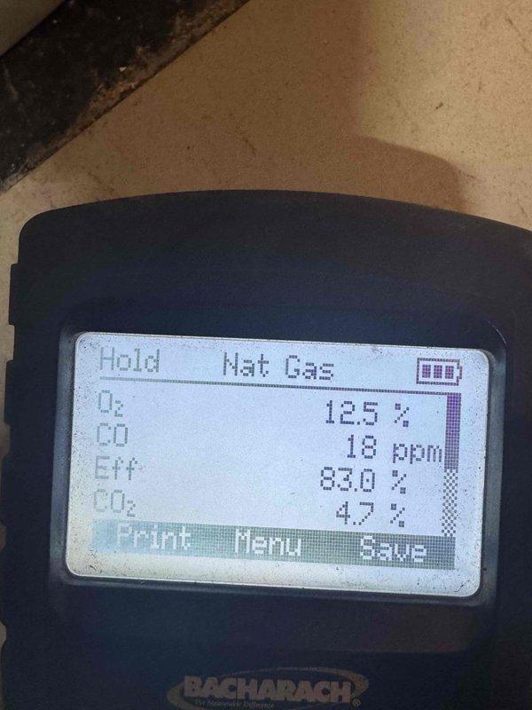 Completed scheduled MVP heating maintenance visit on natural gas heating system. Performed combustion analysis using gas analyzer, recording readings of 12.5% oxygen, 18 ppm carbon monoxide, 83.0% efficiency, and 4.7% carbon dioxide, all within acceptable operating parameters. Inspected and documented control board assembly and electrical connections within equipment cabinet, verifying proper wiring configurations and component operation. System operating normally with no issues identified.