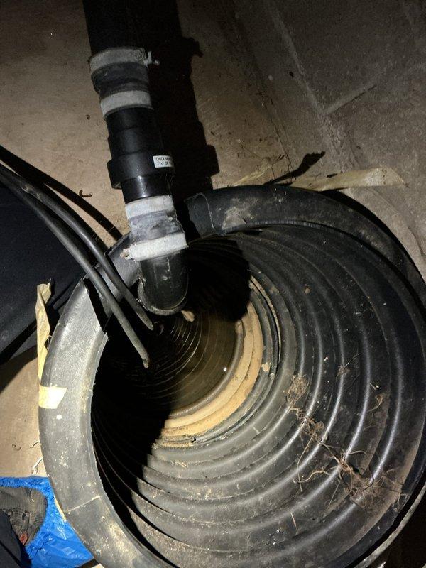 Responded to service call for non-operational sump pump in residential basement. Upon inspection, confirmed existing pump had failed and was no longer functioning. Standing water was present in the sump pit with visible sediment accumulation. Removed failed pump unit from pit and installed new replacement sump pump system. Connected discharge piping with insulated vertical pipe configuration. Verified proper electrical connections and tested pump operation to ensure adequate water removal and automatic float switch functionality. System restored to full working order.