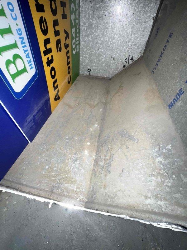 Responded to request for ductwork cleaning assessment and scheduling. Upon inspection, discovered significant mold contamination throughout the ductwork system, with extensive growth visible on interior ceiling surfaces and upper walls of the main plenum and distribution channels. Documented conditions with photographs showing heavy microbial buildup requiring remediation beyond standard cleaning services.