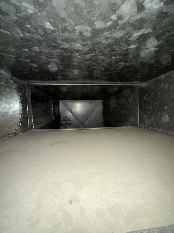 Responded to request for ductwork cleaning assessment and scheduling. Upon inspection, discovered significant mold contamination throughout the ductwork system, with extensive growth visible on interior ceiling surfaces and upper walls of the main plenum and distribution channels. Documented conditions with photographs showing heavy microbial buildup requiring remediation beyond standard cleaning services.