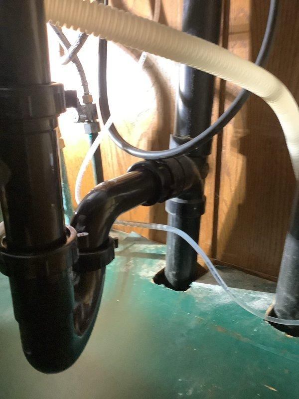 Completed installation of dishwasher drain assembly including strainer components and dish master system. Installed black PVC drainage piping with corrugated flexible discharge hose and clear tubing connections through wall framing. Installed Grundfos circulator pump with copper piping connections for hot water recirculation system. Matrix service charge covered all strainer and dish master installation components. Collected partial payment deposit with balance due upon completion. Parts were ordered for shop delivery, received, and installation completed as scheduled.