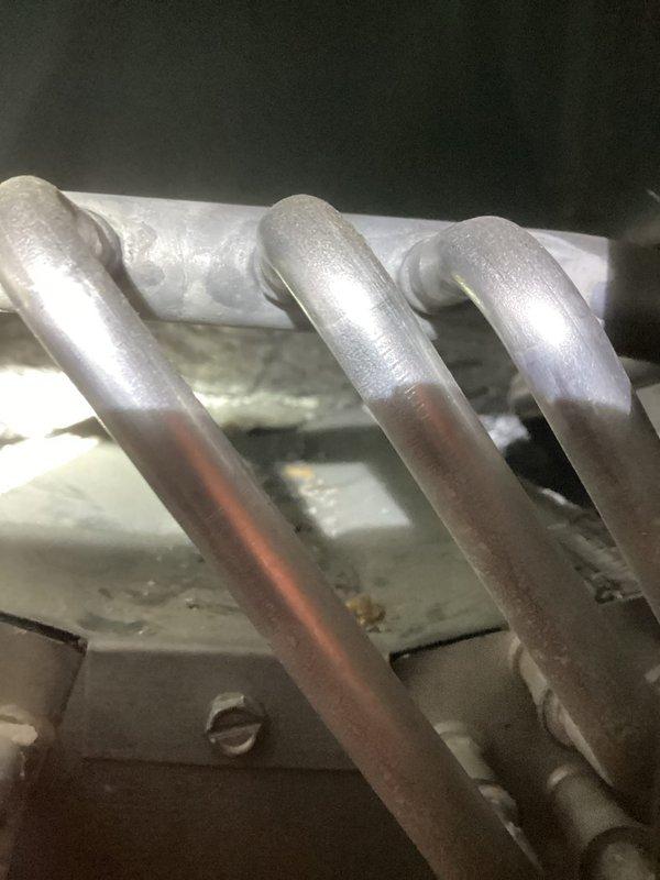 Completed routine air conditioning maintenance and system inspection. Performed visual examination of evaporator coil assembly, refrigerant lines, compressor unit, and electrical connections. All components found in satisfactory operating condition with proper wiring configuration and secure mounting hardware intact.