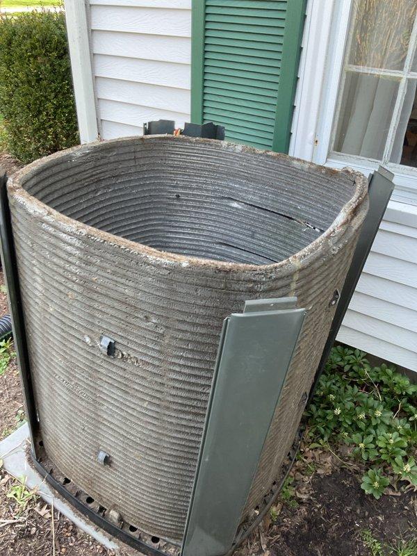 Completed MVP cooling maintenance visit on cylindrical condenser unit with ribbed aluminum coil design. Performed standard preventive maintenance inspection of outdoor unit positioned on concrete pad against house exterior. Documented equipment condition showing normal weathering and minor dirt accumulation on coil fins consistent with outdoor exposure. Unit operational with all components functioning within normal parameters. Access panels and electrical connections inspected and found secure. Photographed equipment for service records.