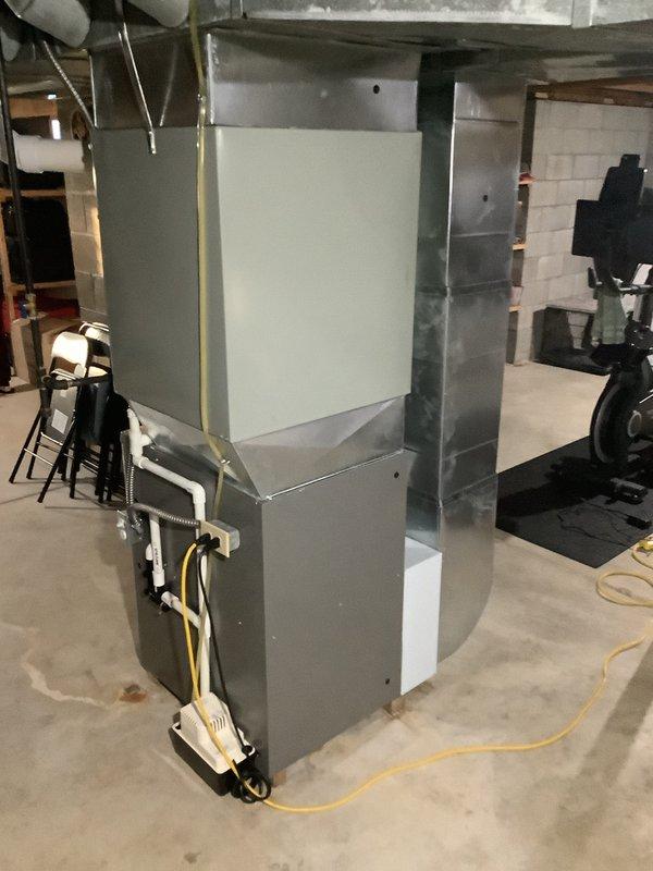 Completed first-time installation of new air conditioning system with evaporator coil integrated with existing furnace unit in basement mechanical room. Installed and properly routed all refrigerant lines, condensate drainage piping, and electrical connections, ensuring secure mounting with appropriate strapping and support brackets throughout the system.