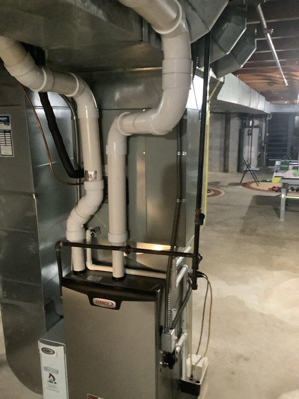 Completed first-time installation of new air conditioning system with evaporator coil integrated with existing furnace unit in basement mechanical room. Installed and properly routed all refrigerant lines, condensate drainage piping, and electrical connections, ensuring secure mounting with appropriate strapping and support brackets throughout the system.