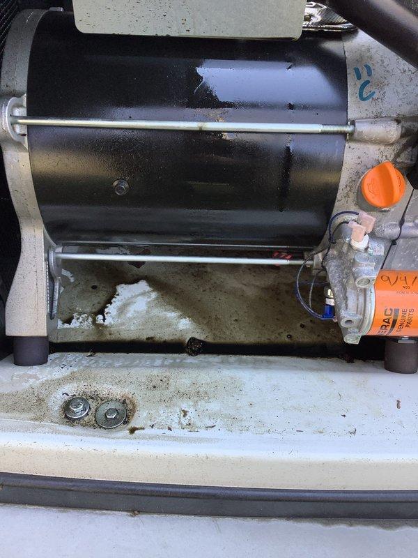 Performed scheduled generator maintenance following extended runtime of approximately 100 hours over a four-day period during recent storm event. Inspected unit and identified oil leak requiring further evaluation. Documented equipment condition through photographs showing motor assembly, mounting hardware, and fluid management components. Service placed on hold pending technical consultation to determine appropriate repair approach for the oil leak issue.