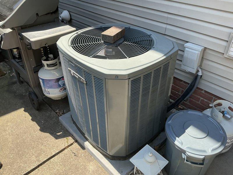 Conducted on-site evaluation and provided replacement estimate for existing 12-year-old residential HVAC system including both furnace and air conditioning components. Documented current equipment configuration showing outdoor condenser unit, air handler, and associated electrical connections and refrigerant lines for comprehensive system replacement proposal.
