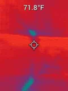 Responded to service call for water leakage from 2-year-old furnace system causing damage to finished basement carpet. Plumbing sources had been previously ruled out by licensed plumber. Performed diagnostic inspection and utilized thermal imaging camera to identify temperature anomalies and moisture intrusion patterns in ductwork and surrounding areas. Thermal scans revealed cool spots indicating active moisture presence at multiple locations, with temperature differentials ranging from 71.8°F to 74.3°F across affected surfaces. Investigation suggests improper condensate drainage or installation deficiencies may be contributing to water accumulation in duct system. Documented findings with thermal imagery showing distinct cool zones consistent with water infiltration. Advised customer of diagnostic results and discussed membership program renewal options.