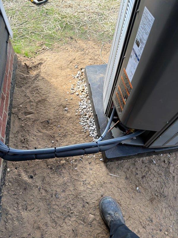 # HVAC Complete System Installation

## Summary
Successfully completed full HVAC system installation including 90% efficiency furnace, air conditioning unit, ductwork infrastructure, and whole-home dehumidifier to provide comprehensive climate control solution.

## Work Performed

**Outdoor Equipment Installation**
Installed new air conditioning condenser unit on prepared foundation pad in exterior location adjacent to building structure. Positioned equipment on leveled base with proper clearances for service access and airflow requirements. Ran refrigerant line set from outdoor unit through protective flexible conduit to interior equipment connection point. Established drainage pathway using decorative rock bed along foundation perimeter to manage condensate runoff and prevent water accumulation around equipment pad.

**Indoor Equipment Installation**
Installed high-efficiency 90% AFUE furnace as primary heating system. Mounted unit on concrete base pad with secure anchoring. Connecte