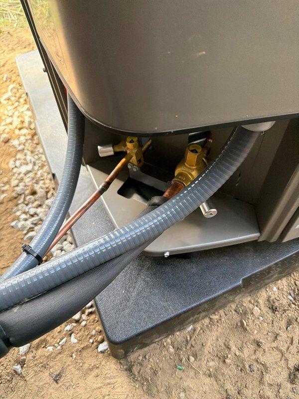 # HVAC Complete System Installation

## Summary
Successfully completed full HVAC system installation including 90% efficiency furnace, air conditioning unit, ductwork infrastructure, and whole-home dehumidifier to provide comprehensive climate control solution.

## Work Performed

**Outdoor Equipment Installation**
Installed new air conditioning condenser unit on prepared foundation pad in exterior location adjacent to building structure. Positioned equipment on leveled base with proper clearances for service access and airflow requirements. Ran refrigerant line set from outdoor unit through protective flexible conduit to interior equipment connection point. Established drainage pathway using decorative rock bed along foundation perimeter to manage condensate runoff and prevent water accumulation around equipment pad.

**Indoor Equipment Installation**
Installed high-efficiency 90% AFUE furnace as primary heating system. Mounted unit on concrete base pad with secure anchoring. Connecte