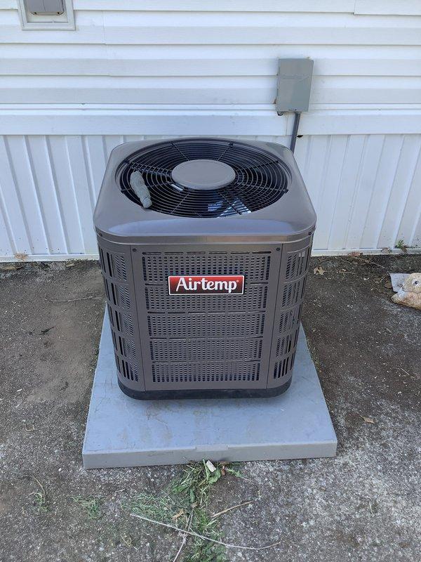 Completed full HVAC system installation for mobile home, including new furnace and air conditioning condenser unit. Installed Airtemp brand outdoor condensing unit on concrete pad against exterior wall with proper clearances and positioning. Mounted electrical disconnect box on exterior siding and ran appropriate conduit connections to power unit. Installed dual run capacitors with proper wiring connections using copper refrigerant lines. Secured all electrical connections with appropriate gauge wiring and verified proper voltage at disconnect. Tested system operation including fan motor function and verified unit cycling properly. All components installed per manufacturer specifications and local code requirements.