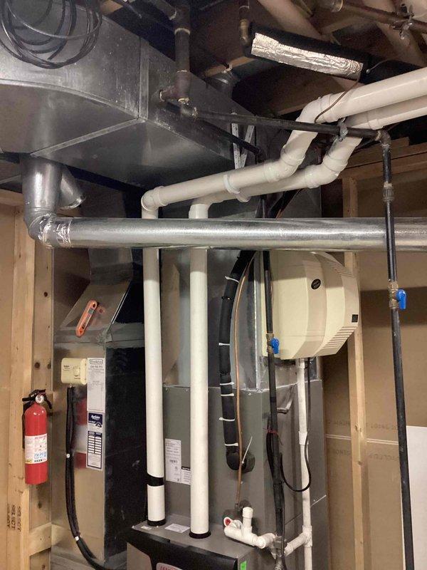 Completed early morning air conditioning tune-up service on residential split system. Performed comprehensive inspection of outdoor condenser unit, noting light debris accumulation on coil fins which was cleaned during service. Inspected indoor air handler and associated refrigerant lines, condensate drainage system, and ductwork connections in mechanical room. All components found operating within normal parameters with no immediate concerns identified.