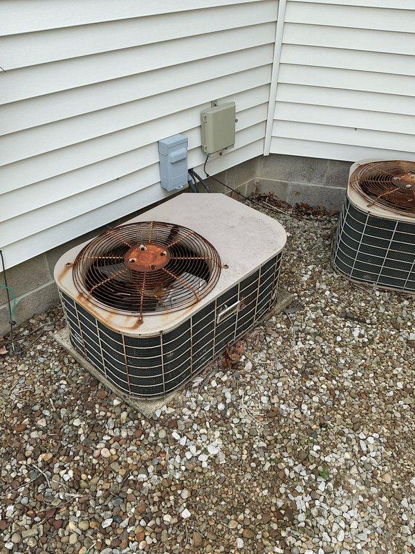 Completed comprehensive estimate for dual HVAC system replacement including two furnaces and two air conditioning units. Assessed existing equipment in mechanical room showing standard ductwork configuration with air handler, and evaluated two outdoor condenser units with the left unit displaying significant rust corrosion and deterioration on top cover and fan assembly. Provided pricing options including promotional offer for AC equipment replacement.