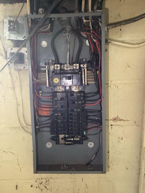 Conducted comprehensive electrical assessment for whole-house rewiring estimate. Inspected existing electrical panel containing dual columns of circuit breakers with main service conductors and distribution bus bars, noting current wiring configuration and capacity. Evaluated utility room mechanical space and HVAC equipment area to determine scope of rewiring requirements throughout the residence. Documented existing electrical infrastructure with photographs and provided detailed estimate for complete residential rewiring project.