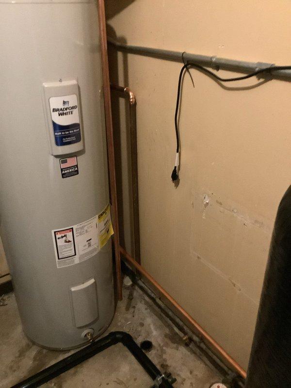 Installed 40-gallon Bradford White water heater, requiring rework of existing copper water lines to accommodate the taller tank configuration. Removed existing laundry sink and properly capped off associated water supply lines. Installation included mounting expansion tank, connecting copper supply and distribution piping with appropriate valves and fittings, and integrating all electrical connections to code. All plumbing connections tested and verified for proper operation and leak-free performance.