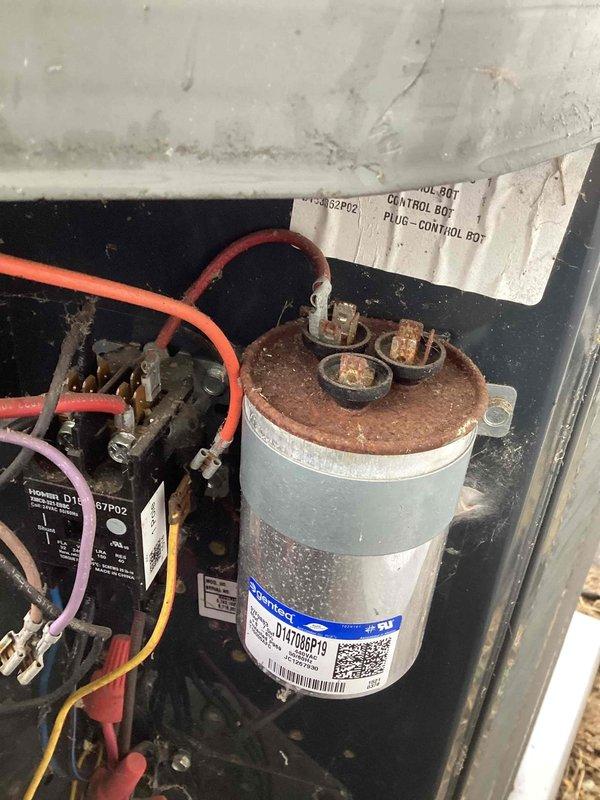 Completed comprehensive AC tune-up service on residential cooling system. Evaporator coil exhibited heavy dust and debris accumulation throughout the cross-hatched mesh surface, significantly restricting airflow and reducing system efficiency. Thoroughly cleaned coil to restore proper heat transfer capability and airflow. Inspected electrical components within control panel and identified capacitor with severe corrosion and oxidation on terminals and metal cap, presenting potential failure risk. Recommended immediate capacitor replacement to prevent system breakdown. Verified all electrical connections, tested system operation, and documented equipment condition with photographic evidence for customer records.