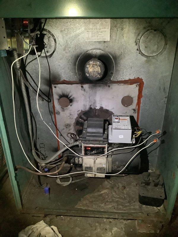 Performed oil furnace maintenance requiring replacement nozzle. Inspected combustion chamber and heat exchanger assembly, noting accumulated soot and carbon deposits on burner components. Ordered necessary nozzle for completion of annual maintenance service, with parts received and customer notified for scheduling of follow-up visit to complete the tune-up procedure.
