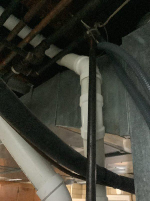 Responded to service call for gas water heater with home gas supply shut off due to existing gas leak. Performed visual inspection of tanked water heater unit of unknown age located in basement utility area. Assessed condition of unit, gas supply lines, water connections, venting system, and associated plumbing components including copper piping, flexible connectors, and shut-off valves. Documented equipment configuration with circulator pump mounted on top of water heater and standard plumbing connections. Provided estimate for gas leak repair and potential water heater replacement options.