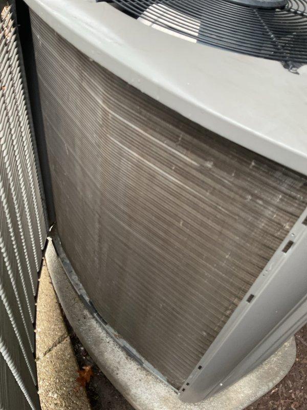 Completed Early Bird A/C Tune-Up on residential cooling system per customer request. Performed comprehensive inspection of outdoor condensing unit, noting significant dust and debris accumulation on condenser coils with visible brownish-gray discoloration affecting heat transfer efficiency. Inspected indoor air filter, which showed moderate dust loading but remained serviceable. Documented unit condition with photographs showing horizontal fin coils requiring attention and filter assembly with proper installation. System operational at time of service with fan assembly functioning normally.