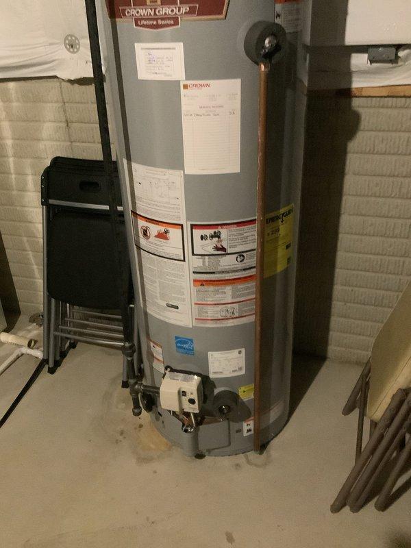 Performed routine maintenance flush on residential Crown Group tanked water heater to remove sediment buildup and ensure optimal performance. Confirmed all plumbing connections, including copper supply lines and circulation pump system, were functioning properly with no visible leaks or deterioration. Unit inspected and verified to be in normal operating condition with proper venting and standard residential installation intact.