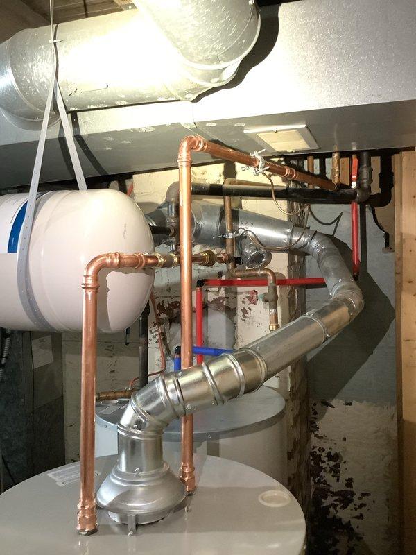 Removed existing 40-gallon tall water heater and installed new 40-gallon short Bradford White water heater with 6-year manufacturer warranty to improve flue pipe pitch and ventilation clearance. Replaced corroded gate valve with new ball valve on cold water supply line. Installed 4.8-gallon thermal expansion tank to protect plumbing system from thermal expansion pressure. All copper piping connections completed with proper fittings and secured according to code. System tested for leaks, proper operation verified, and thermal expansion tank pre-charged to appropriate pressure.