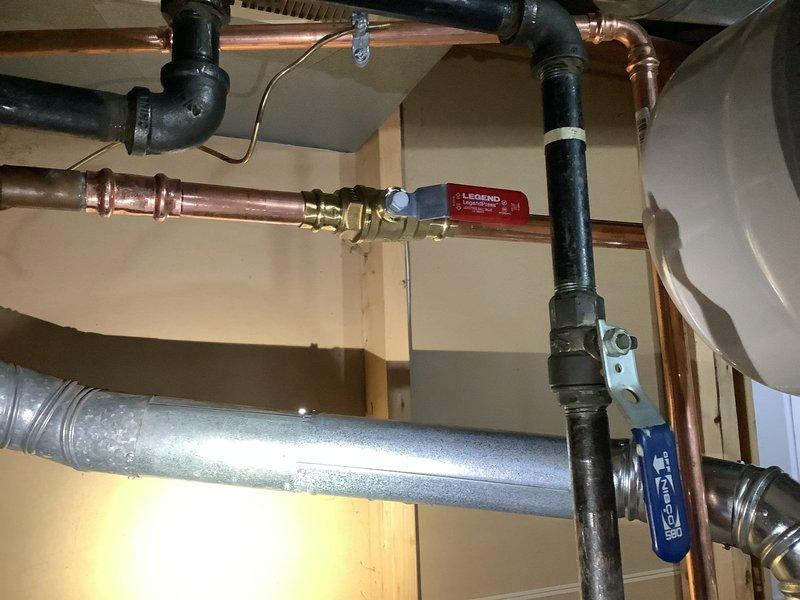 Removed existing 40-gallon tall water heater and installed new 40-gallon short Bradford White water heater with 6-year manufacturer warranty to improve flue pipe pitch and ventilation clearance. Replaced corroded gate valve with new ball valve on cold water supply line. Installed 4.8-gallon thermal expansion tank to protect plumbing system from thermal expansion pressure. All copper piping connections completed with proper fittings and secured according to code. System tested for leaks, proper operation verified, and thermal expansion tank pre-charged to appropriate pressure.