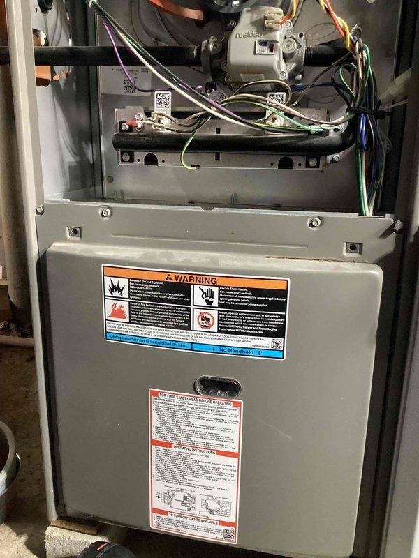 Completed preventive maintenance tune-up on a 3-year-old residential air conditioning system. Performed comprehensive inspection of indoor furnace components and outdoor condensing unit. Outdoor condenser coil exhibited heavy accumulation of dirt, dust, and debris throughout the fin surfaces, with particularly dense buildup in the central and upper portions; cleaned coil to restore proper airflow and heat transfer efficiency. Noted minor fin damage on right side of coil during inspection. Verified all electrical connections, checked refrigerant pressures, and confirmed proper system operation. Indoor furnace unit inspected with blower motor, gas valve, and control wiring all found in acceptable condition. System operating within normal parameters upon completion. Documented equipment condition with photographs for service records.