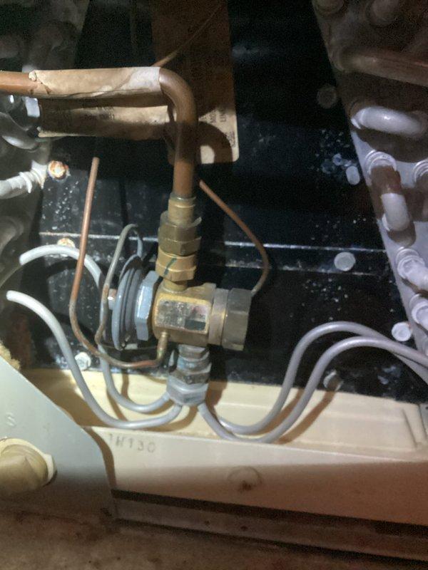Completed MVP heating maintenance visit on residential HVAC system. Performed comprehensive inspection of gas furnace components including gas control valve assembly, burner chamber, and heat exchanger. Documented condition of equipment showing age-related wear patterns and rust discoloration on burner chamber surfaces. Inspected refrigeration circuit components including brass flow control valve, copper refrigerant lines, filter drier, and associated piping connections with insulation intact and properly maintained.
