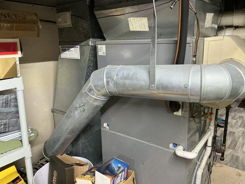 Completed comprehensive HVAC system replacement estimate for 21-year-old furnace and air conditioning system in residential basement mechanical room. Assessed existing ComfortMaker furnace unit, air handler, associated ductwork, and condensate drainage system including PVC trap configuration. Documented current equipment condition, metal plenum construction, copper piping, and galvanized ductwork routing. Prepared three separate quote options for complete furnace and AC replacement to address aging equipment nearing end of serviceable life.