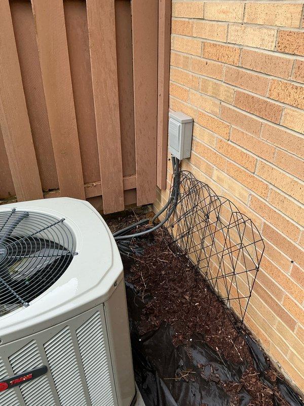 Conducted on-site evaluation for complete HVAC system replacement following air conditioning failure. Assessed existing outdoor condenser unit positioned in exterior corner area between structure and privacy fence, noting electrical disconnect and conduit configuration. Evaluated indoor air handler equipment located in basement utility space and examined existing ductwork infrastructure. Documented current system specifications, electrical service requirements, and installation conditions to develop comprehensive replacement proposal for new HVAC system.