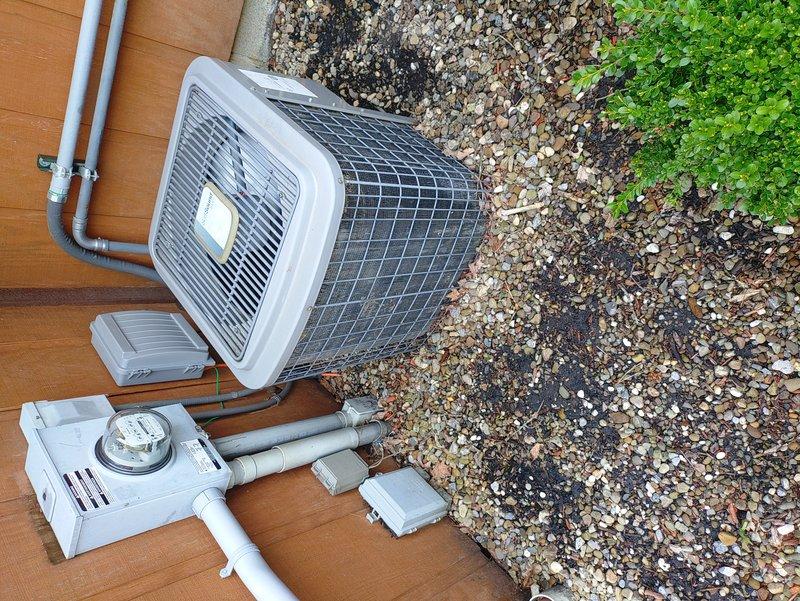 Performed diagnostic inspection of outdoor A/C condenser unit. Found unit installed directly on wooden deck without proper equipment pad, causing unit to lean and creating potential for long-term structural damage and reduced system efficiency. Documented existing installation conditions with photos showing improper mounting configuration and lack of level foundation. Advised customer that unit requires proper concrete or composite equipment pad and leveling to ensure optimal operation, prevent vibration damage, and maintain manufacturer warranty compliance.