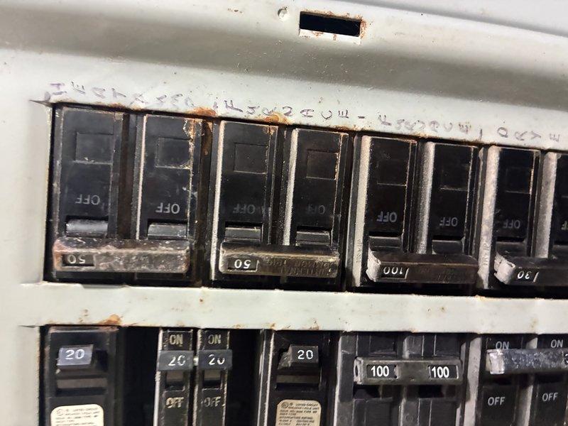 Responded to no-heat call on one-year-old heat pump with tripped circuit breaker. Upon inspection, discovered extensive rust and corrosion throughout the electrical panel affecting breaker terminals, bus bars, and mounting hardware, indicating significant moisture intrusion. Documented hazardous electrical conditions with corrosion present on terminal connections and recommended immediate panel replacement by licensed electrician before heat pump system could be safely restored to operation.