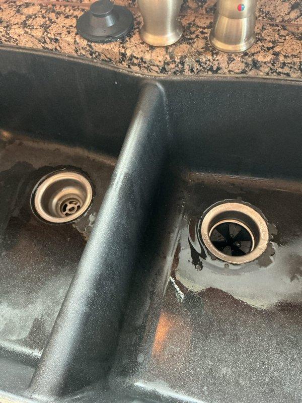 Completed comprehensive plumbing repairs including replacement of kitchen drain line in basement, installation of new garbage disposal unit under double-basin kitchen sink, and full rebuild of half bathroom. Replaced Kohler toilet tank-to-bowl gasket to eliminate leak and ensure proper seal. All work performed with helper assistance, parts pre-ordered and staged prior to service call to ensure timely completion without delays.