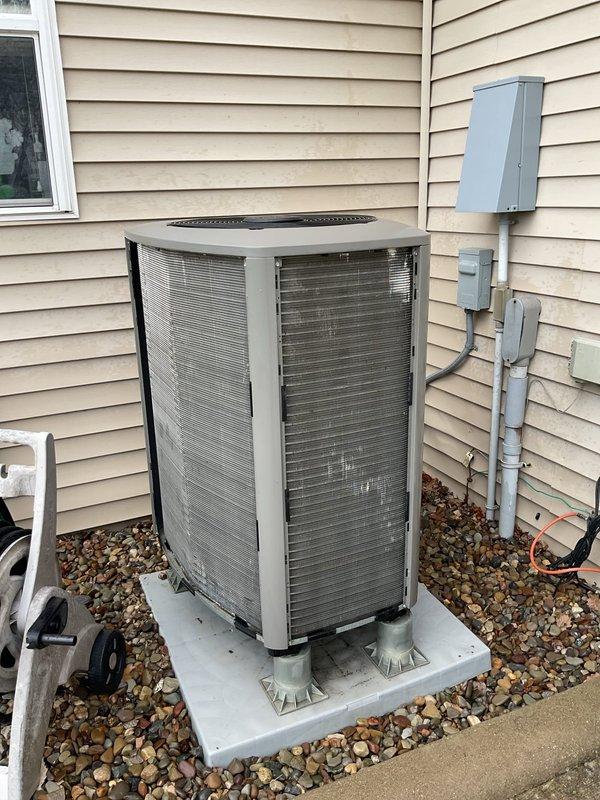 Completed routine maintenance inspection on 4-year-old air conditioning system for customer reporting slight operational noise. Performed visual assessment of outdoor condensing unit, verified proper installation on concrete pad with appropriate elevation and clearances, and confirmed unit levelness using precision measuring tools. All components appeared in good working condition with no immediate concerns identified.