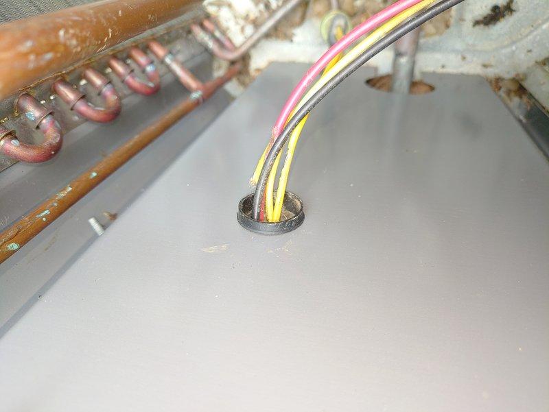 Responded to no-cooling call on five-year-old air conditioning unit. Upon arrival, found unit completely inoperative with no power to system. Performed diagnostic inspection of electrical components and wiring connections at equipment. Identified failed low-voltage wiring connection at control board causing loss of thermostat communication. Repaired damaged wire bundle, secured connections through panel grommet, and restored proper electrical continuity. Verified all wire terminations, tested system operation, and confirmed unit cycling properly with adequate cooling output. System returned to normal operation.