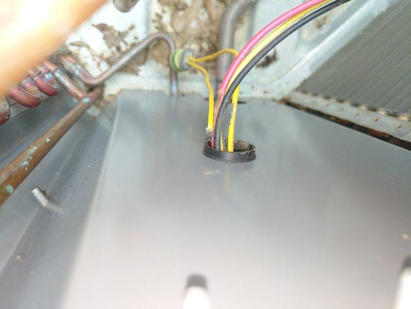 Responded to no-cooling call on five-year-old air conditioning unit. Upon arrival, found unit completely inoperative with no power to system. Performed diagnostic inspection of electrical components and wiring connections at equipment. Identified failed low-voltage wiring connection at control board causing loss of thermostat communication. Repaired damaged wire bundle, secured connections through panel grommet, and restored proper electrical continuity. Verified all wire terminations, tested system operation, and confirmed unit cycling properly with adequate cooling output. System returned to normal operation.