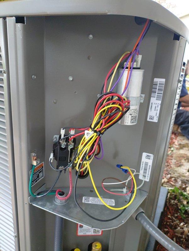 Completed full HVAC system installation including furnace, air conditioning unit, tankless water heater, and sump pump. Installed outdoor condensing unit with proper refrigerant line connections utilizing black foam insulation and copper piping, secured electrical wiring harness with multi-conductor connections to contactor assembly, and mounted disconnect box on exterior wall per code requirements. All equipment installed on appropriate pads, tested for proper operation, and verified electrical connections at all termination points.