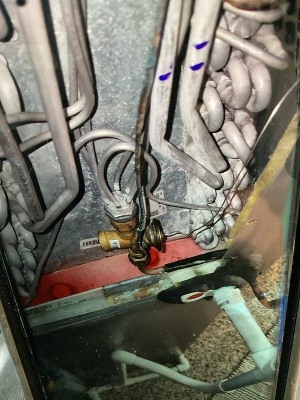 Completed comprehensive spring maintenance on four-year-old cooling system. During inspection, discovered evaporator coil with heavy frost accumulation indicating restricted airflow or possible refrigerant issue. Documented system components including air handler assembly, electrical connections, and drainage system; verified proper wire routing and mechanical connections throughout unit.