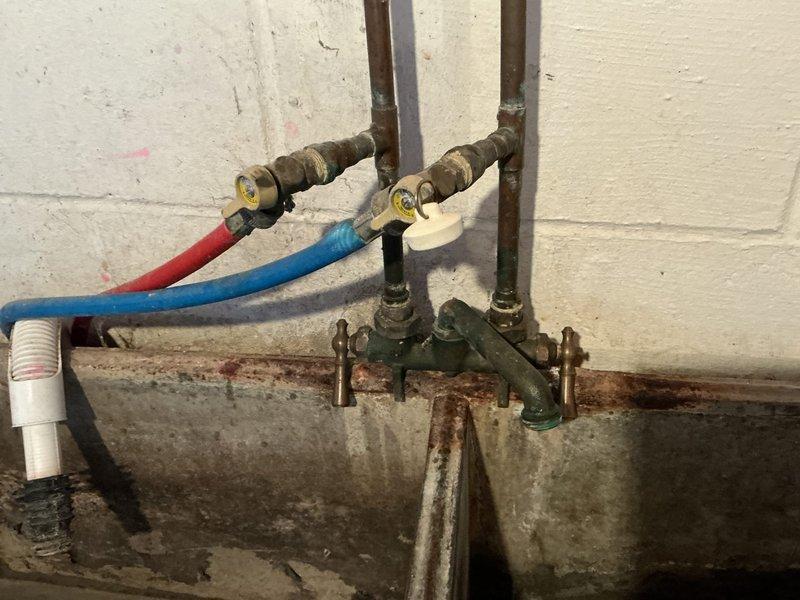 Conducted on-site evaluation for furnace replacement estimate in residential basement utility area. Documented existing HVAC infrastructure, plumbing connections, and spatial constraints including exposed ceiling joists, PVC drainage lines, and utility meter locations. Assessed clearance requirements and access pathways for equipment removal and installation, noting storage shelving and aged plumbing manifold assembly with corroded fittings in work vicinity. Provided comprehensive replacement recommendations and scheduling coordination per customer availability.